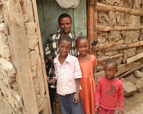 Adolfina (wearing the orange dress) with her mother and two brothers