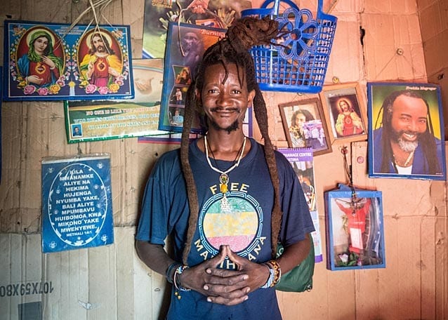 The first room, adorned with pictures of Christ and Bob Marley, has only just enough room for a couch and a small table where they cook and eat meals.