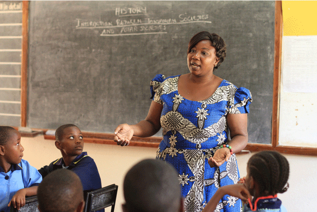 Helping hands: Eunice with her Grade 5 social studies class in 2014.