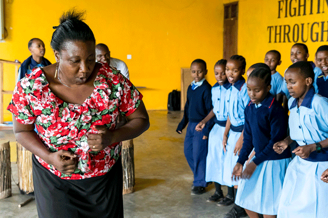 Do as I do: Eunice teaching her traditional dance club.