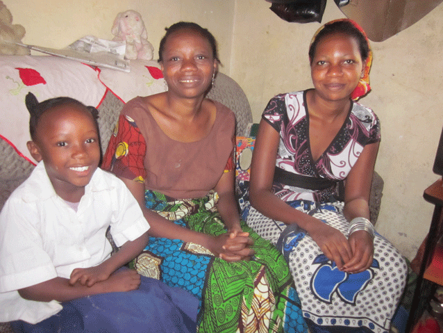 Strong role model: Glory at home with her daughters, Noreen and Deborah.