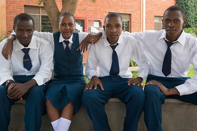 Remember the days of the old school yard: Emmanuel (right) in Form 6 (Grade 12) with his friends.