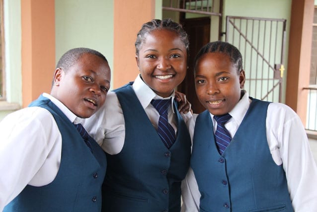 Spreading the joy: The high-quality education Anna (right), and friends Mkesa (left) and Kudra, received during their schooling at St Jude's has put her in prime position to help others in her community.