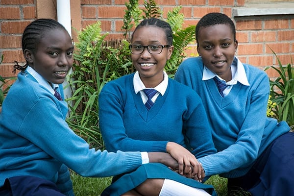 Caring and confidence: Big sister Kareen (center) encourages her sisters, Jackline (left) and Janeth (right) to be confident.