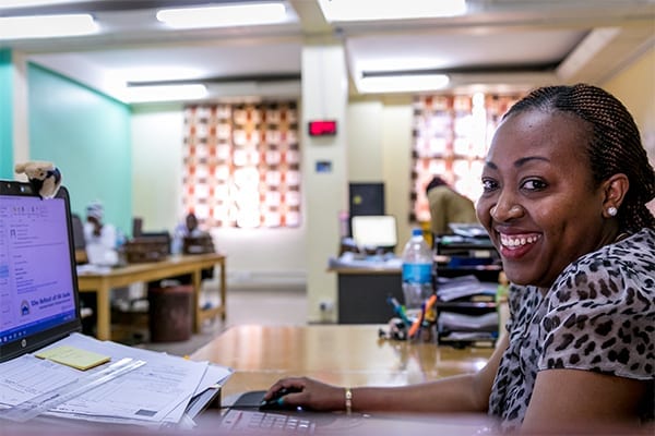 The smile that launched a thousand currency exchanges: Norah loves meeting visitors at the accounts window.