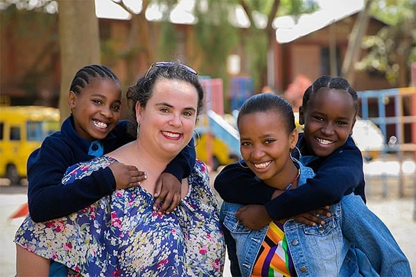 Sisters doing it for their community: Gemma, Winrose and St Jude's students share a moment of fun.