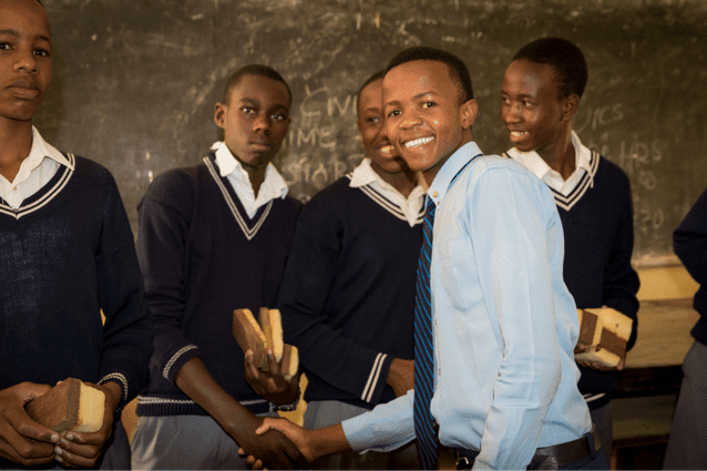 Community spirit: Form 3 student Eric was happy to be able to give the gifts to students at Oldadai Secondary School.