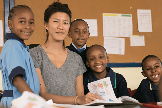 Learning together: Connie with Vivian and other St Jude’s students, enjoying a book.