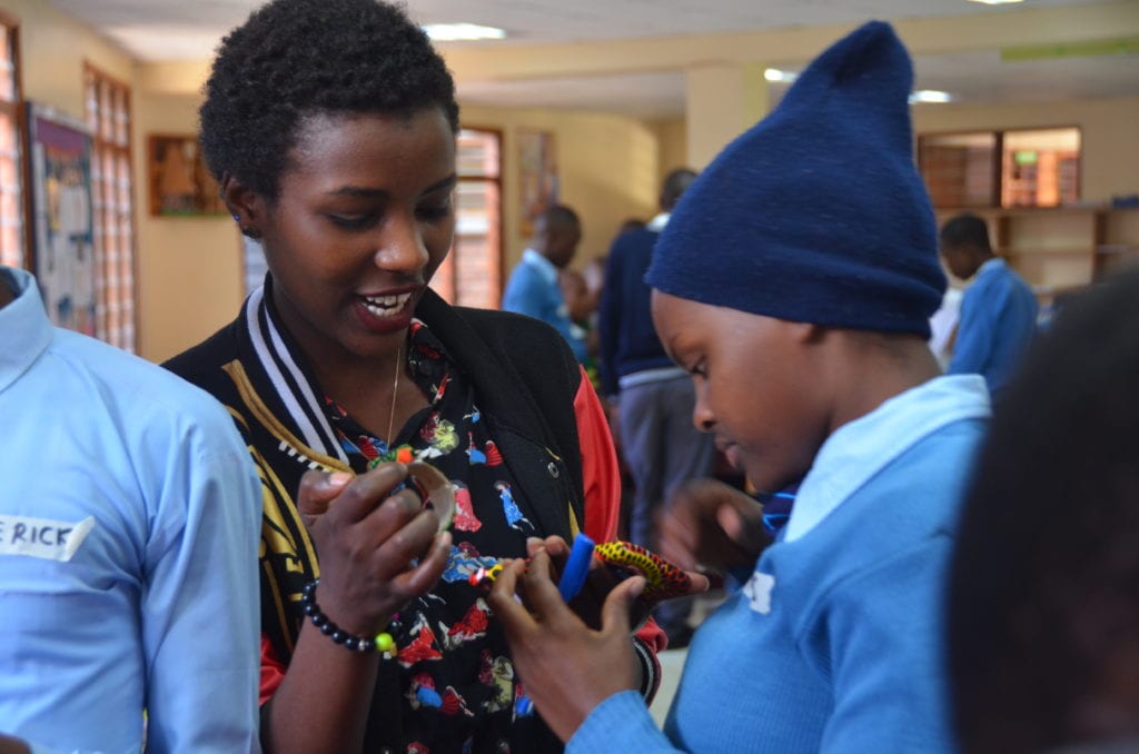 A helping hand: Workshop facilitator, Miriam, supports a student during the interactive session.