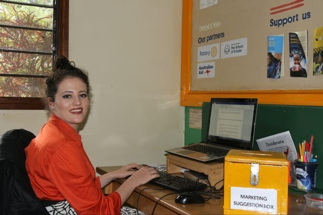 Working hard, smiling strong: Our new arrival takes her post in the Marketing department.