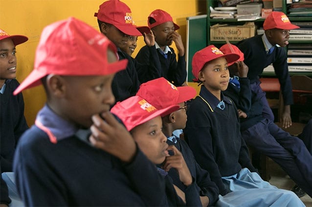 Red-y for action: The Earlyact club wearing their End Polio Now caps at their meeting.