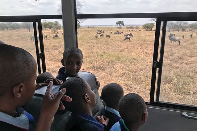 On the lookout: It was clearly a tough day in the classroom for the keen young sightseers!