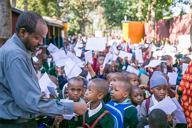 Holding onto hope: Academic Deputy, Sebastian Gitbang, assists hundreds of determined students.
