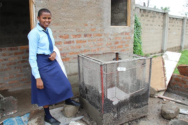 Warm heart, cool project: Eunice at the 2014 Science Exhibition with her refrigerator.