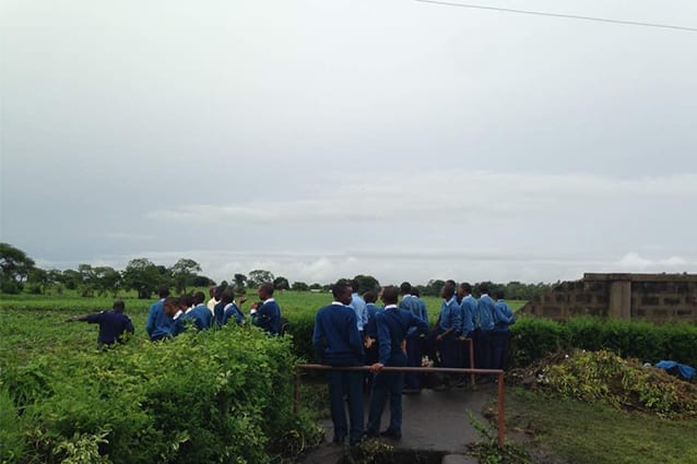 Curious onlookers: Students at the rear boundary, surprised by the storm's effects. School Founder, Gemma Sisia, was shocked to see the impact the heavy rain made on the wall, which has ensured students’ safety and weathered many storms since it was first built more than 10 years ago. 