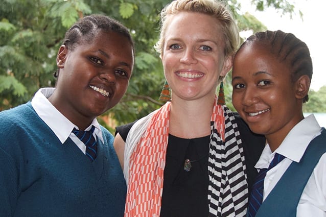 Grinning graduates: Angela in 2016, with two students who had attended St Jude's since the early days.