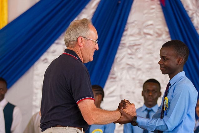 Guest of Honour: Brian congratulates a student at the Form 4 Awards ceremony.