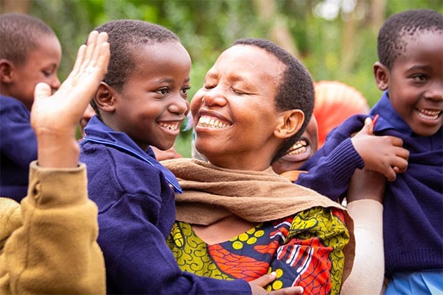 Proud mama: Veraeli holds Getruda high after she receives her new school uniform.