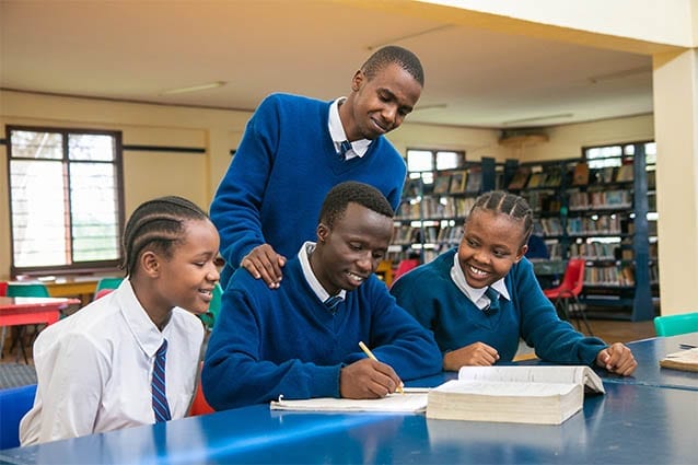 Hard work pays off: Godwin studying in the library during Form 6 with his classmates.