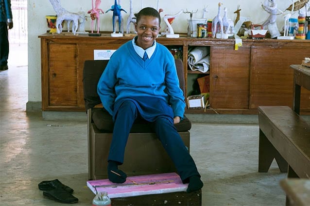 Overcoming adversity: Lightness in art class painting with her feet.