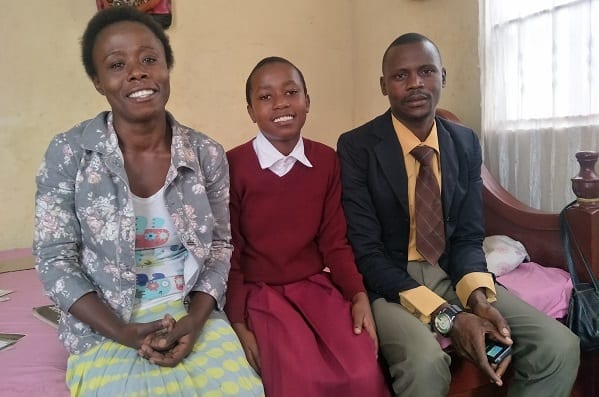 Overcoming Obstacles: Beatrice in her one-room home with her parents.