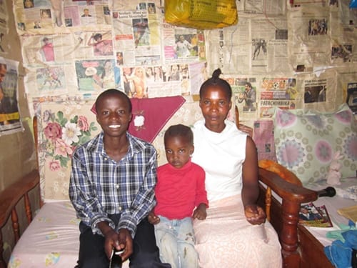 Humble beginnings: Godwin with his mother and young sister shortly before he started at St Jude's.