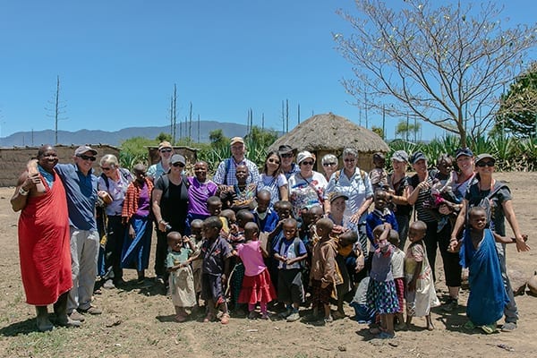 Cultures Combine: Visitors with Massai tribe members at Langidare village.