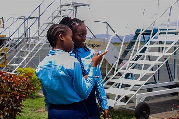 On the ground: Form 1 students discuss the logistics of the runway at the Kilimanjaro International Airport. 