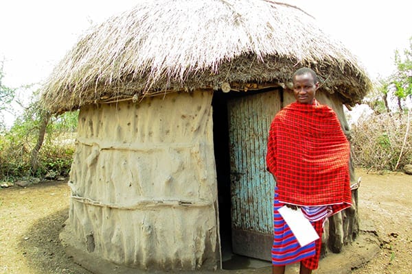 Pipe Dream: Baba outside his traditional Maasai boma in 2003 shortly before he joined St Jude's, with dreams of attending University.