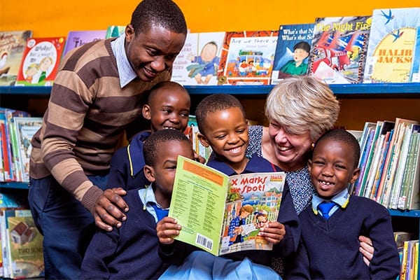 The Gift of Literacy: Librarians who are implementing the new web-based system spend time with the Standard 1 students.