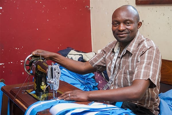 Job Opportunity: Daudi is one of 5 tailors employed by the school.