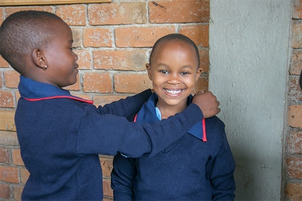 School Spirit: Standard 1 students trying on their new uniforms.