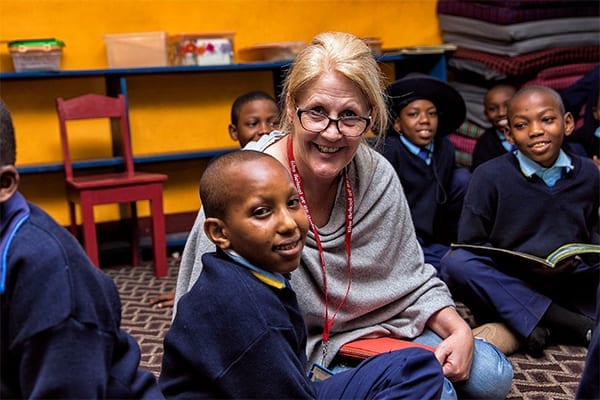 Reading time: Tina takes some quiet time out in the library with students at Sisia Primary Campus.