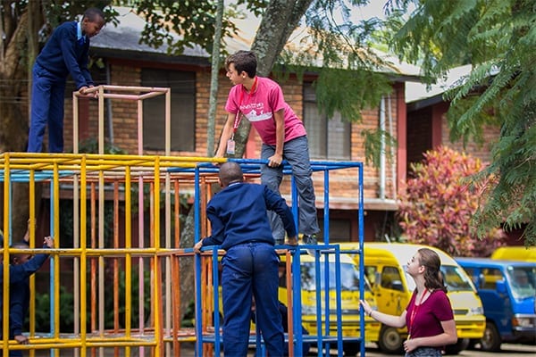 Recess time: Lance surveying the playground with sister Julie and St Jude's students.  