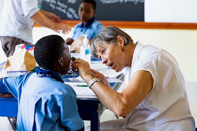 Open Wide: Dr Astrid, checking a student’s dental hygiene. 