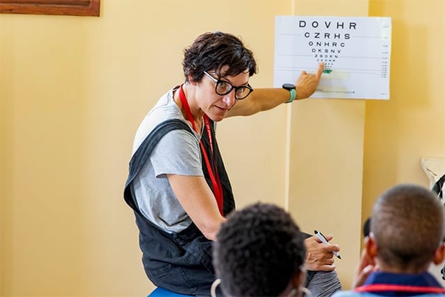 K for Koala!: Caroline carrying out an eye examination with a primary student.