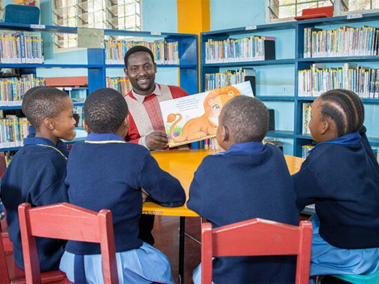 Teacher-and-students-at-St-Jude-Primary-Library