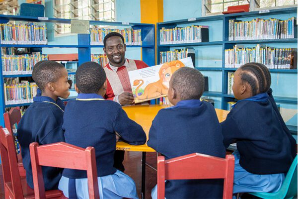 Teacher-and-students-at-St-Jude-Primary-Library